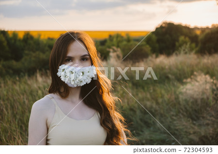 New normal, lockdown, face mask. Outdoor portrait of woman in protective face Statement Masks with flowers on nature background. Blinged out diy face mask design. Girl in face mask decorated flowers. New normal, lockdown, face mask. Outdoor portrait of woman in protective face Statement Masks with flowers on nature background. Blinged out diy face mask design. Girl in face mask decorated flowers. 72304593