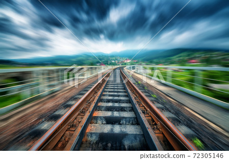 Railroad bridge in overcast day with motion blur effect Railroad bridge in overcast day with motion blur effect 72305146