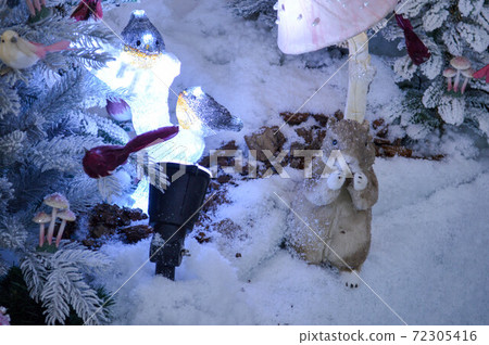 Winter background with squirrel decor and garland lights Winter background with squirrel decor and garland lights 72305416