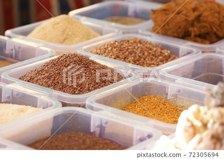 Flax seeds and other healthy seasonings in plastic boxes. Flax seeds and other healthy seasonings in plastic boxes. 72305694