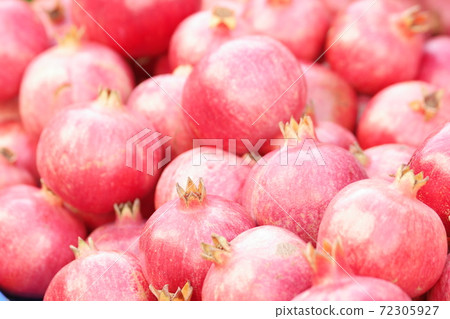 Pile of red ripe pomegranate fruits as background. Pile of red ripe pomegranate fruits as background. 72305927