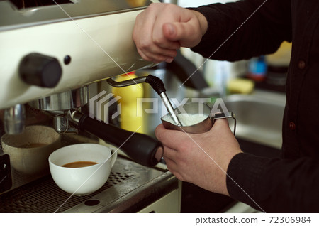 The process of whipping milk in a coffee machine 72306984