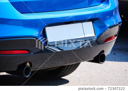 Close up of car exhaust pipe on the street Close up of car exhaust pipe on the street 72307222