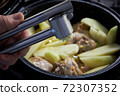 Garlic by the press is added to the dish of potatoes and turkey 72307352