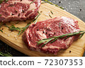 Two raw beef slices for barbecue on wooden board 72307353