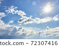 Beautiful fluffy clouds on a blue sky background on a sunny day 72307416