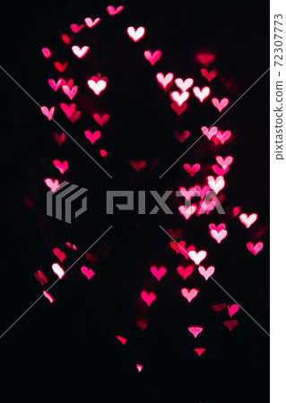 Defocused bokeh lights in shape of pink and red hearts. Defocused bokeh lights in shape of pink and red hearts. 72307773