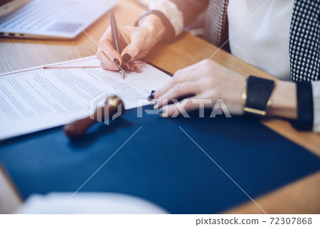 Lawyer, notary, attorney signs the documents. 72307868
