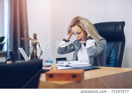 Terrified and furious notary public in his notary office. Terrified and furious notary public in his notary office. 72307877