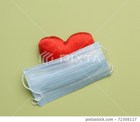 disposable masks on a green background, hygiene and virus protection accessories 72308117