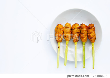 Grilled minced chicken with curry paste and coconut cream on lemongrass skewers. Top view Grilled minced chicken with curry paste and coconut cream on lemongrass skewers. Top view 72308608