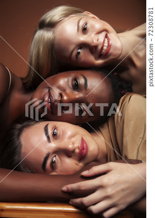 young pretty asian, caucasian, afro woman posing cheerful together on brown background, lifestyle diverse nationality people concept young pretty asian, caucasian, afro woman posing cheerful together on brown background, lifestyle diverse nationality people concept 72308781