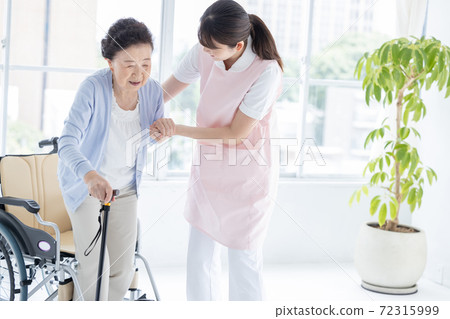 Long-term care image: A caregiver who helps senior women stand up 72315999