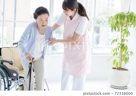Long-term care image: A caregiver who helps senior women stand up 72316000