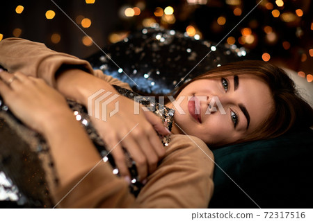 beautiful young woman with long hair is lying on the bed beautiful young woman with long hair is lying on the bed 72317516