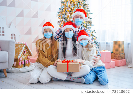 Happy young family with kids holding christmas presents 72318662