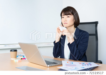 A woman who cares about rough skin because of a mask in the office A woman who cares about rough skin because of a mask in the office 72319517