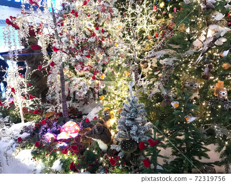 A festively decorated Christmas tree with bows, balls and garlands 72319756