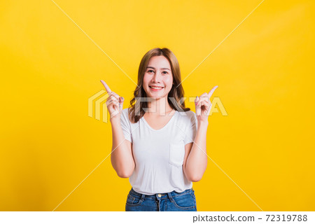 woman teen standing makes gesture two fingers point upwards above woman teen standing makes gesture two fingers point upwards above 72319788