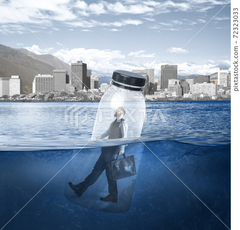 Office worker, businessman closed in bottle heading to work on the river with megapolis on the background Office worker, businessman closed in bottle heading to work on the river with megapolis on the background 72323033