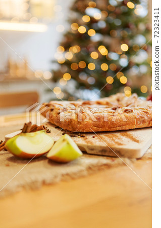 New Year's, Christmas culinary composition from food of generic background, intentionally blurred post production. cake with apples for the new year's table. Bokeh as background. New Year's, Christmas culinary composition from food of generic background, intentionally blurred post production. cake with apples for the new year's table. Bokeh as background. 72323411