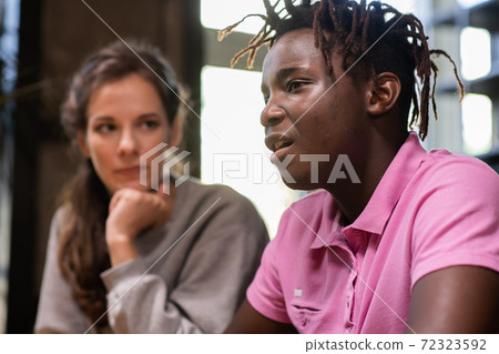 A girl is listening to her classmate, while he is expressing his A girl is listening to her classmate, while he is expressing his 72323592
