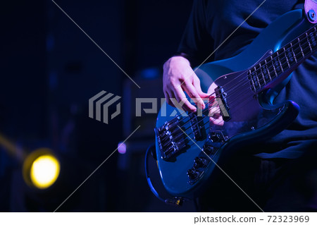 Guitarist bass on stage for background, colorful, soft focus and blur Guitarist bass on stage for background, colorful, soft focus and blur 72323969