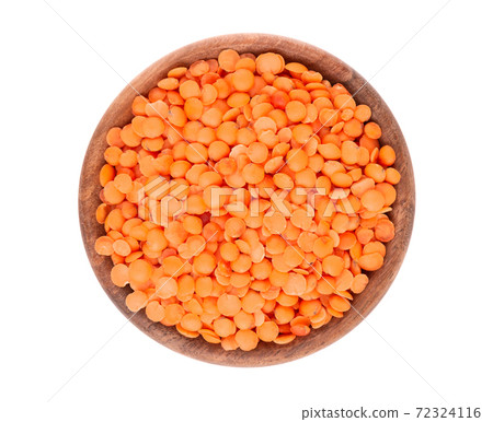 Red lentils in wooden bowl isolated on white background. Top view. Red lentils in wooden bowl isolated on white background. Top view. 72324116
