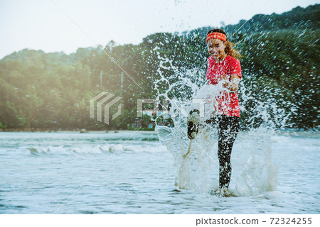 asian woman jogging workout on the beach in the morning. Relax with the beach. fun and happy with playing, jumping, kicking the sea. in summer asian woman jogging workout on the beach in the morning. Relax with the beach. fun and happy with playing, jumping, kicking the sea. in summer 72324255