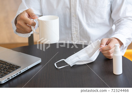 A man's hand putting a mask on the table A man's hand putting a mask on the table 72324466