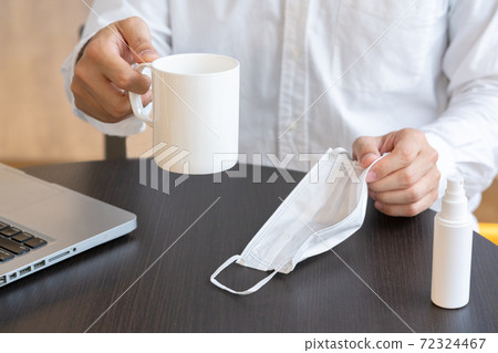A man's hand putting a mask on the table A man's hand putting a mask on the table 72324467