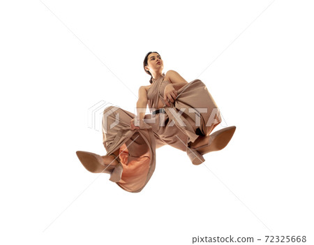 Young stylish woman in modern street style outfit isolated on white background, shot from the bottom Young stylish woman in modern street style outfit isolated on white background, shot from the bottom 72325668