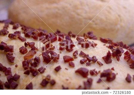Fresh home baked breads, make out of wheat, one simple and one with pepperoni on top Fresh home baked breads, make out of wheat, one simple and one with pepperoni on top 72326180