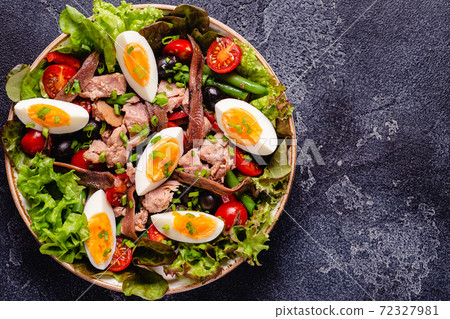salad Nicoise with tuna, eggs, green beans, tomatoes,  olives, lettuce and anchovies 72327981