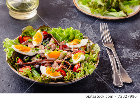 salad Nicoise with tuna, eggs, green beans, tomatoes,  olives, lettuce and anchovies 72327986