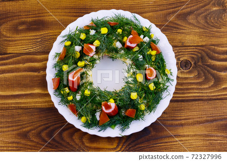 Salad Christmas wreath on a wooden table. Top view 72327996