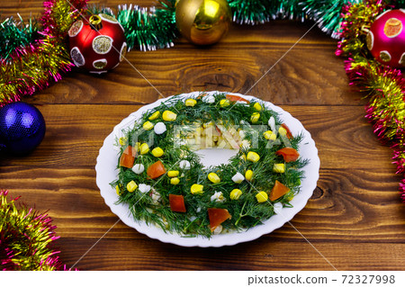Salad Christmas wreath and Christmas decorations on a wooden table 72327998
