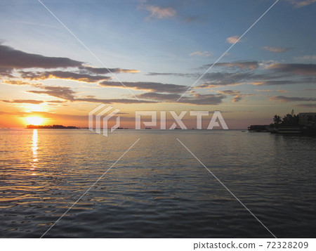Sunset over the sea in Makassar, Indonesia (wide) 72328209