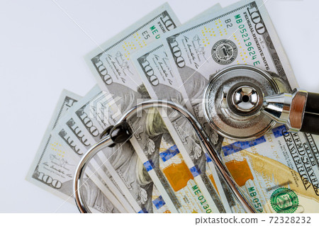Stethoscope in US dollar bills on medical costs healthcare payment of paid medicine. 72328232