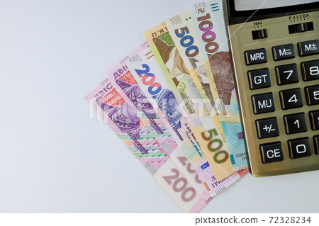 Financial accounting calculate the calculator on the Ukrainian money hryvnia banknotes with white background 72328234
