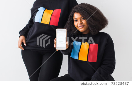 African american woman showing blank phone screen, mockup African american woman showing blank phone screen, mockup 72328487
