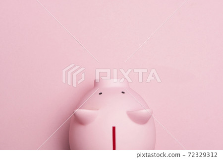 Close up of  a pink piggybank seen from a high anlge view on a pink background as concept for financial issues 72329312
