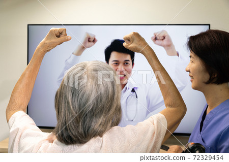 Elderly woman using physical therapy online service at home. Elderly woman using physical therapy online service at home. 72329454