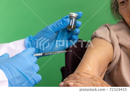 Chroma key, nurse doing vaccine injection to senior woman. Chroma key, nurse doing vaccine injection to senior woman. 72329455