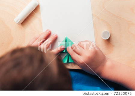 Child making Christmas card from paper. Step 5 Child making Christmas card from paper. Step 5 72330075