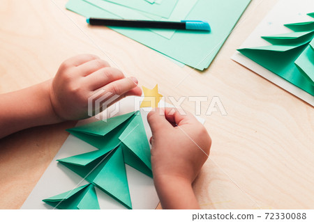 Child making Christmas card from paper. Step 6 Child making Christmas card from paper. Step 6 72330088