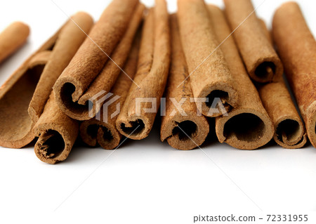 Cinnamon close up on a white background Cinnamon close up on a white background 72331955