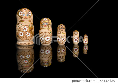 Wooden Russia matrioshka dolls in a row on a blackground Wooden Russia matrioshka dolls in a row on a blackground 72332189