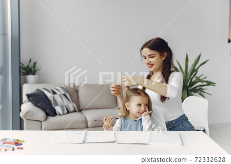 Tutor with litthe girl studying at home Tutor with litthe girl studying at home 72332628