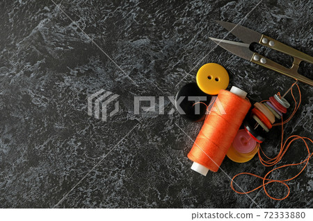 Sewing supplies on black smokey background, space for text 72333880